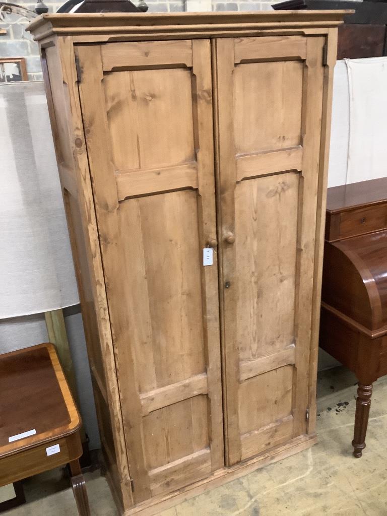 A Victorian panelled pitched pine two door cabinet, width 108cm depth 40cm height 198cm